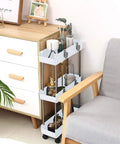 Sleek 3 Tier Slim Rolling Storage Cart With Slide Out Shelves For Tight Squeezes in pure white beside a grey chair, perfect for clutter control.