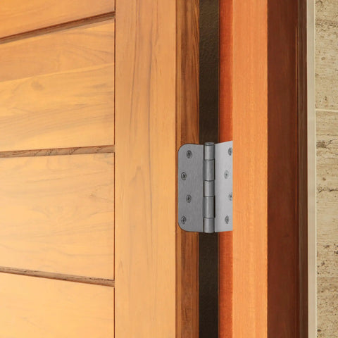 Four Inch Satin Nickel Interior Door Hinges Two Pack on a wooden door, showcasing smooth action and durable steel build.