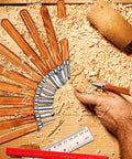 Wood Carving Knife Set 20 Piece Kit With Carbon Steel Blades And Electrolytic Coating in use on wood block, ruler nearby.