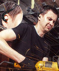 Man wearing banded earplugs for shooting range with silicone band, lightweight hearing protection in construction setting