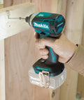 Person using 18V LXT Brushless Cordless Impact Driver with Quick-Shift Mode on wood construction