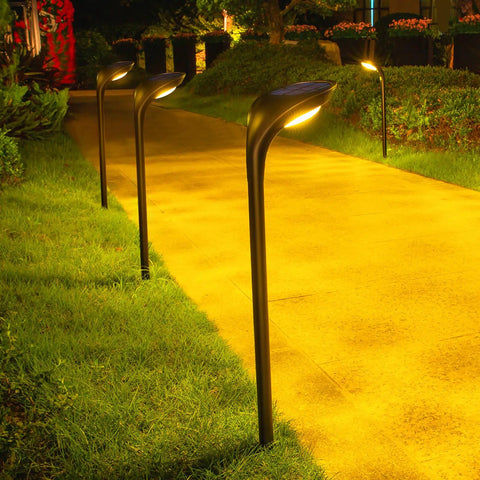 4-Pack 150 Lumen Solar Pathway Lights Waterproof Landscape Lighting illuminating a garden walkway at night