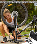 Black Bike Handlebar Stabilizer Stand With Quick Release Clip On For 29 To 34 Millimeters Grips Inverted Parking And Maintenance Tool in use during bike repairs in a park setting.