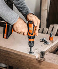User operating Battle Ready Heavy Duty Cordless Drill Driver Featuring Four Speed Rugged Metal Gearbox Brushless Motor on wood.