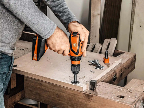 User operating Battle Ready Heavy Duty Cordless Drill Driver Featuring Four Speed Rugged Metal Gearbox Brushless Motor on wood.