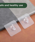 Clear Adhesive Hooks Zero Drama Strong Grip for Shower Wall Organizers No Damage Pegs Bathroom Storage 12 Pieces Nifty Transparent Holder on surface.