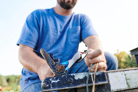 Person using 9.5 Inch Wire Crimping Tool For Insulated And Non Insulated Terminals With Center Cut Pliers outdoors on wiring project