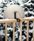 Dang Solid Heated Bird Bath Locks Tight To Deck Railings Frost Proof Stone Basin 150w Heater Tip Hinge Drain Easy Cleanup Top Shelf Backyard Bird Bathing Station mounted on snowy deck rail.