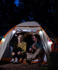 Two people sitting in a tent illuminated by Three Pack Portable LED Camping Lights With Three Modes High Low And Strobe Lightweight ABS Bulbs.