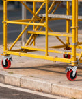 Tough As Nails 6 Inch Scaffolding Caster Wheels With Reliable Brake And Easy Adjustable Leveling Jacks on yellow scaffold.