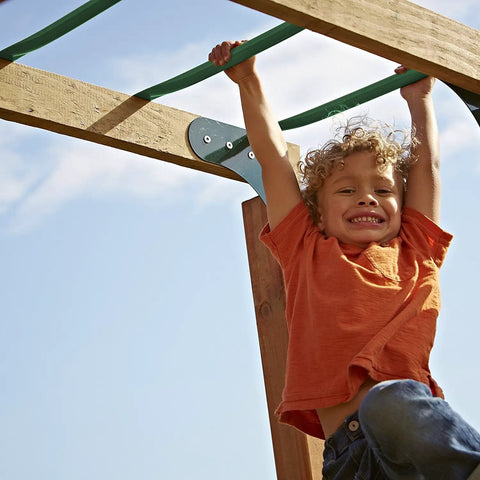 Child swinging on Metal Monkey Bars Set With Six 21.5 Inch Rungs, Includes Hardware, Built Tough For Backyard Swing Sets