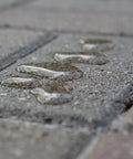 Water droplets on textured stone surface showing waterproof properties of Premium Patio Paver Sealer Low Gloss Water Based Clear Stone Sealant Tough As Nails For Driveways.