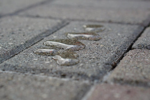 Water droplets on textured stone surface showing waterproof properties of Premium Patio Paver Sealer Low Gloss Water Based Clear Stone Sealant Tough As Nails For Driveways.