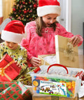 Children opening gifts with Epic 170 Piece Building Set For Kids Ages 3 To 9 With Toy Box Storage and Idea Guide, Christmas scene