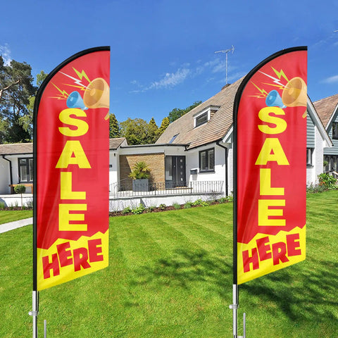 Two 11 ft Sale Here Feather Flag Swooper With Flagpole Kit and Ground Stake in front of a house, outdoor advertising flag sign