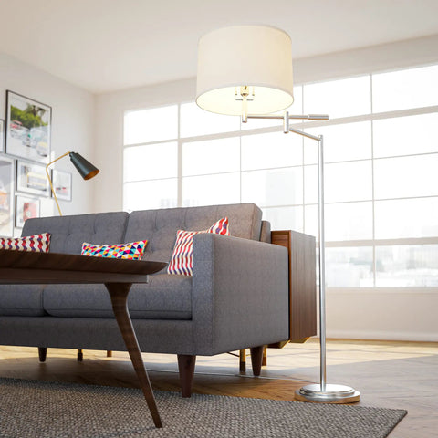 Theta Swing Arm Floor Lamp With Brushed Steel Finish beside gray sofa in modern living room.
