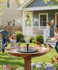 Family enjoying garden view with 2.5W Solar Bird Bath Fountain Pump With 6 Nozzle Patterns, birds around fountain.