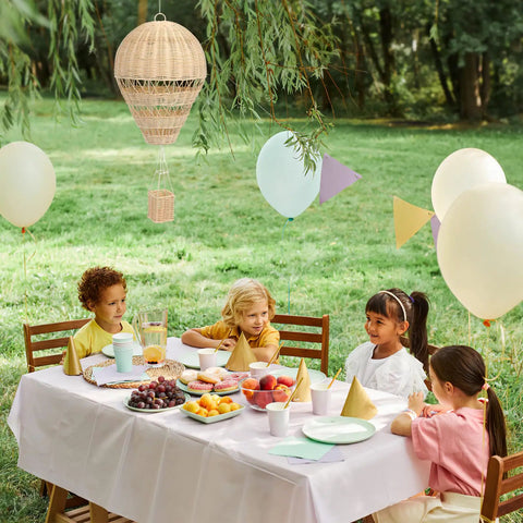 Children's outdoor party with Rattan Woven Hot Air Balloon Wall Decor For Kids Room Cute Nursery Hanging Ornament. Cozy, boho style.