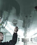 Person using Kraftform Kompakt 20 7-Piece Bit Kit With Pouch, Bayonet Blade, Rapidaptor Quick-Release under aircraft wing.