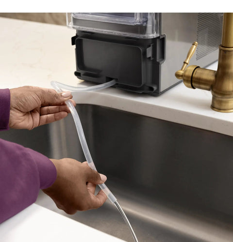 No Cap Portable Nugget Ice Maker Countertop Machine connects water line for easy filling near sink.