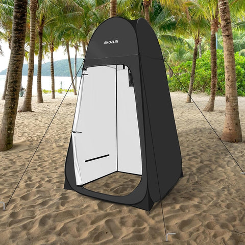Portable Pop Up Shower Tent With Instant Privacy Dressing Room for Camping, black tent on the beach under palm trees.