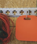 Small Square Hook For E-Track And X-Track Systems, Flat Bottom Design, installed on track with orange pad hanging