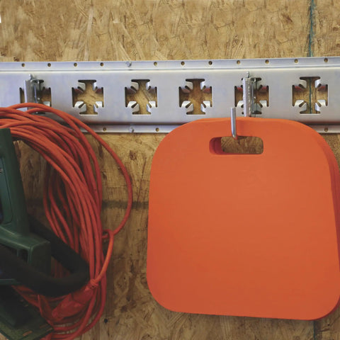 Small Square Hook For E-Track And X-Track Systems, Flat Bottom Design, installed on track with orange pad hanging