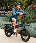 Person on Foldable 20 Inch Fat Tire Electric Bike For Adults With 1200W Peak Motor And 48V Battery, black aluminum frame