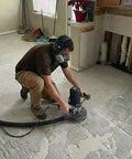 Worker using 7 Inch Concrete Grinder With Low Vibration Handle, 2000W High Torque Motor, 6 Speed Controller on concrete floor