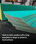 Stack of Green Corps Stikit Sheet Two And Three Quarters Inch By Sixteen And Half Inch 36 Plus Grit Production Sheets on a surface