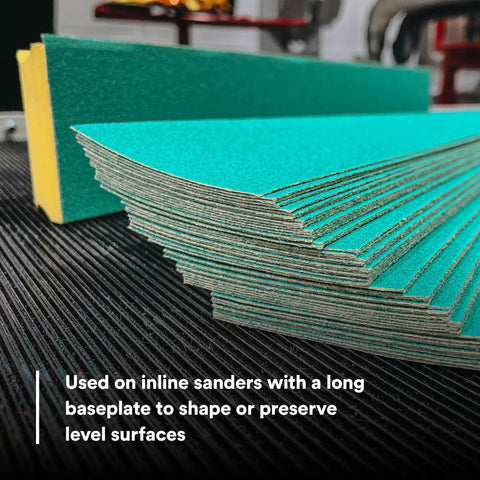 Stack of Green Corps Stikit Sheet Two And Three Quarters Inch By Sixteen And Half Inch 36 Plus Grit Production Sheets on a surface