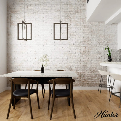 Woodburn One Light Pendant Light In Brushed Nickel Dimmable Modern Rectangle Fixture hanging in a dining room