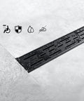 Close-up of Dope Rectangular 36 Inch Matte Black Shower Drain with brickwork pattern grate in brushed 304 stainless steel.