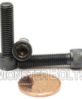Snag These Rugged 1/4-28 X 1 Inch Socket Head Cap Screws With Thermal Black Oxide Coating Heavy Duty Alloy Steel Fasteners To Knock Out Any Home Shop Or Commercial Gig Today 10 Pack. Image showing two black oxide coated screws next to a penny for scale.