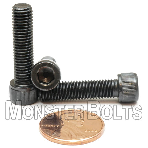 Snag These Rugged 1/4-28 X 1 Inch Socket Head Cap Screws With Thermal Black Oxide Coating Heavy Duty Alloy Steel Fasteners To Knock Out Any Home Shop Or Commercial Gig Today 10 Pack. Image showing two black oxide coated screws next to a penny for scale.
