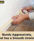 Applying Contractor Grade Masking Tape 0.94 Inch By 60.1 Yard Pack Of 36 Rolls, High Adhesion Painter Tape near floorboard