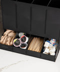 Four Compartment Coffee Pod Dispenser For Breakroom Holds Up To 120 Pods Keeps Your Coffee Station On Point Black Plastic Organizer With Easy Access Tray Measures Fourteen And A Half Inches By Nine Inches By Twelve And A Quarter Inches, displaying coffee pods, stirrers, and creamers neatly organized.