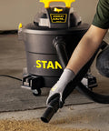 Person using Wet Dry Vacuum With 10 Gallon Tank, 4 HP Motor, 16 Ft Cleaning Reach, Workhorse Shop Vacuum for debris cleanup