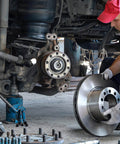 Mechanic installing brake disc on vehicle with hydraulic floor jack, highlighting Five Pack Hydraulic Jack Oil Plugs For Floor And Bottle Jacks Flat Head Reservoir Filler Plugs Rubber Bung Replacement Accessories Fits 0.55 Inch Hole 14mm Universal Fit For Horizontal Jacks Easy Snap In.