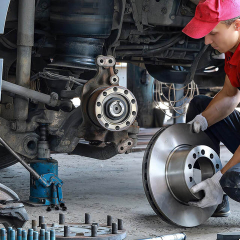 Mechanic installing brake disc on vehicle with hydraulic floor jack, highlighting Five Pack Hydraulic Jack Oil Plugs For Floor And Bottle Jacks Flat Head Reservoir Filler Plugs Rubber Bung Replacement Accessories Fits 0.55 Inch Hole 14mm Universal Fit For Horizontal Jacks Easy Snap In.