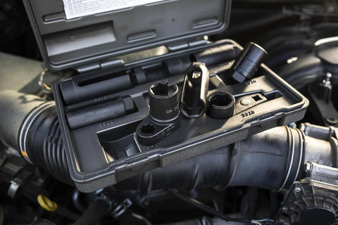 Pro Grade Sensor And Sending Socket Set For Oxygen Sensors And Vacuum Switches Three Eighths Drive Includes Seven Eighths Slotted Socket For O2 Units And Twenty Two Millimeter Sensor Uni Socket Eight Piece Kit in open case shown in engine setting