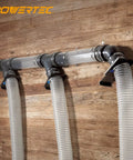 Super Handy Two And A Half Inch Dust Collection Fittings Kit with elbow connectors and hoses mounted on workshop wall