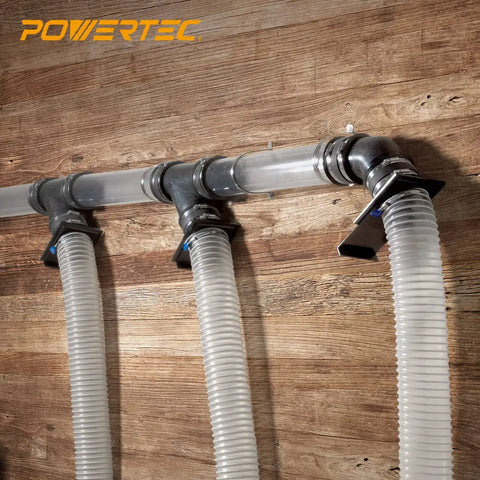 Super Handy Two And A Half Inch Dust Collection Fittings Kit with elbow connectors and hoses mounted on workshop wall
