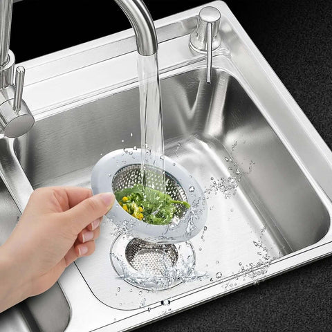 Hand holding Two Pack Stainless Steel Kitchen Sink Strainer Set With Large Wide Rim Four Point Five Inch Diameter Micro Perforated