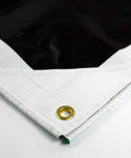 Close-up of Ultra Heavy Duty Waterproof Tarp 12 Ft By 16 Ft 16 Mil Thick with reinforced corner and brass grommet, white side visible.