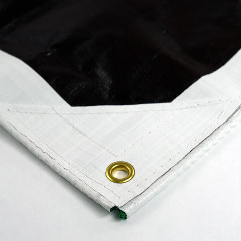 Close-up of Ultra Heavy Duty Waterproof Tarp 12 Ft By 16 Ft 16 Mil Thick with reinforced corner and brass grommet, white side visible.