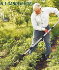 Man using Long Handle 2 In 1 Weed Puller Tool With Garden Hoe And Weed Rake for home gardens in lush green yard