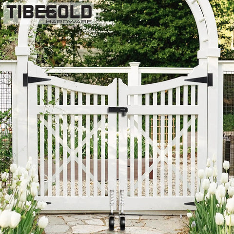 Heavy Duty 5 Inch Spring Loaded Gate Caster Smooth Operator Design For Outdoor Wooden Fences Rock Solid Anti Sag Support Wheel With 360 Degree Swivel And Durable White Housing Handles 220 Lbs No Sweat seen mounted on a white garden gate.