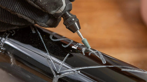 Close-up of All-Purpose Rotary Tool Accessory Kit With 110 Pieces Including Carving Bit Sanding Drums Grinding Stones Cutting Discs And A Storage Case Gray Ideal For DIY Projects And Home Improvement Tasks used for engraving.