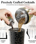 Top Shelf Insulated Cocktail Shaker Set With Double Wall Stainless Steel Body And Integrated Jigger Strainer pouring drinks with a jigger cap.